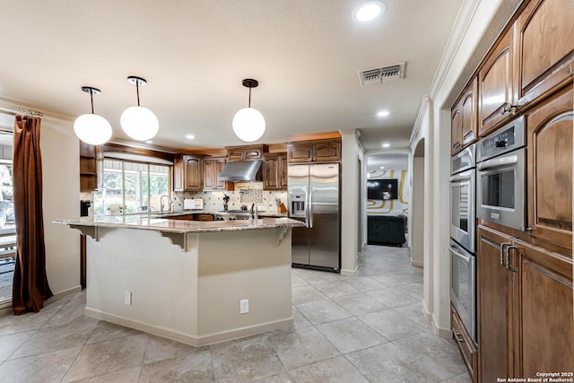 113 Wickford, Castle Hills, TX 78213 - kitchen with appliances with stainless steel finishes, a breakfast bar, under cabinet range hood, light stone countertops, and recessed lighting