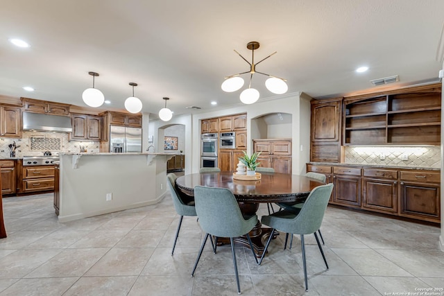 113 Wickford, Castle Hills, TX 78213 - dining room featuring arched walkways, recessed lighting, light tile patterned floors, and a chandelier