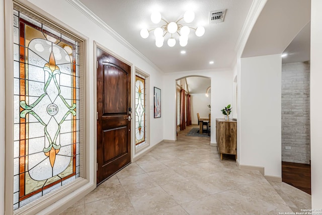113 Wickford, Castle Hills, TX 78213 - foyer with arched walkways, a chandelier, ornamental molding, light tile patterned floors, and baseboards