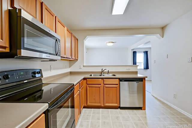 3634 Lazy Clover, San Antonio, TX 78261 - kitchen featuring stainless steel appliances, a sink, brown cabinetry, and a peninsula