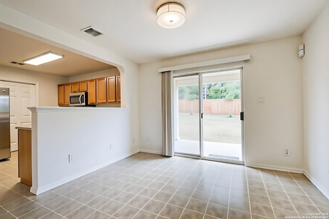 3634 Lazy Clover, San Antonio, TX 78261 - unfurnished room with light tile patterned flooring, baseboards, and arched walkways