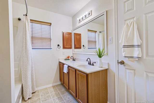 3634 Lazy Clover, San Antonio, TX 78261 - full bath with double vanity, shower / bathtub combination with curtain, and baseboards