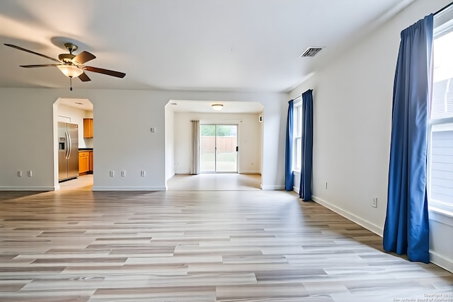 3634 Lazy Clover, San Antonio, TX 78261 - empty room featuring a ceiling fan, light wood-style floors, baseboards, and arched walkways