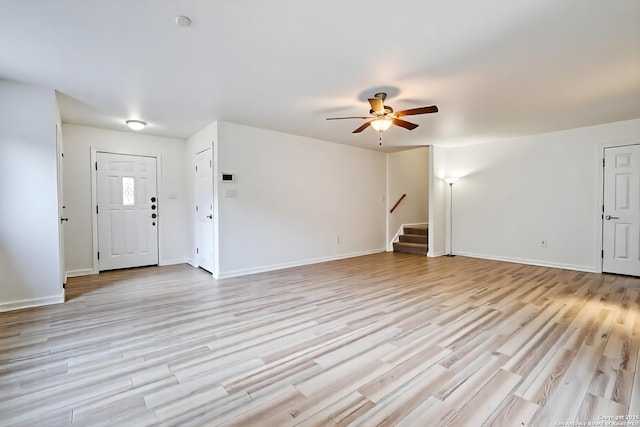 3634 Lazy Clover, San Antonio, TX 78261 - unfurnished living room with a ceiling fan, stairs, light wood finished floors, and baseboards