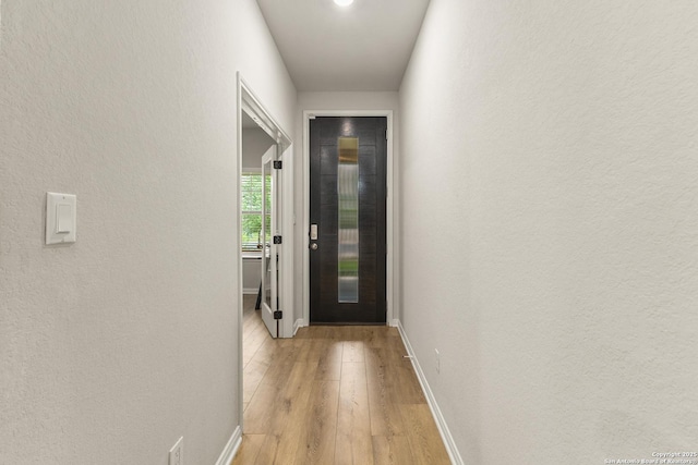 10226 Amaryllis, Boerne, TX 78006 - entryway with light wood-style floors, baseboards, and a textured wall