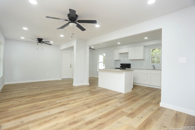 242 Babcock Rd, San Antonio, TX 78201 - unfurnished living room with a sink, recessed lighting, light wood finished floors, ceiling fan, and baseboards