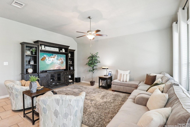 2730 Tortuga Verde, San Antonio, TX 78245 - living area with a ceiling fan, vaulted ceiling, baseboards, and light tile patterned floors