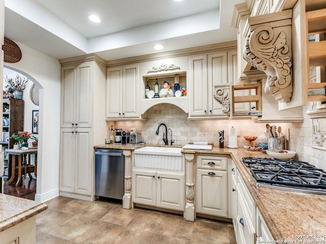 3318 Stone Cave, San Antonio, TX 78247 - kitchen with stainless steel appliances, a sink, arched walkways, open shelves, and backsplash