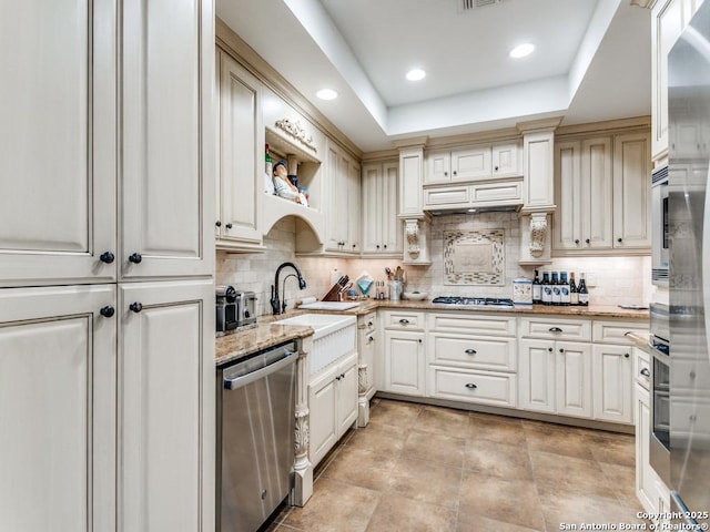 3318 Stone Cave, San Antonio, TX 78247 - kitchen with stainless steel appliances, a sink, decorative backsplash, light stone counters, and recessed lighting