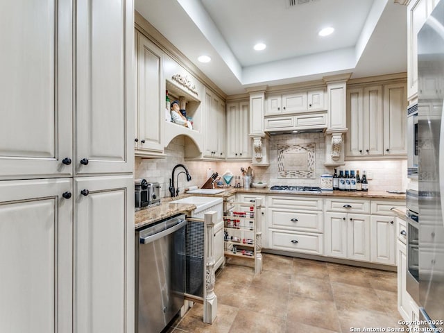 3318 Stone Cave, San Antonio, TX 78247 - kitchen with appliances with stainless steel finishes, a sink, tasteful backsplash, light stone counters, and recessed lighting