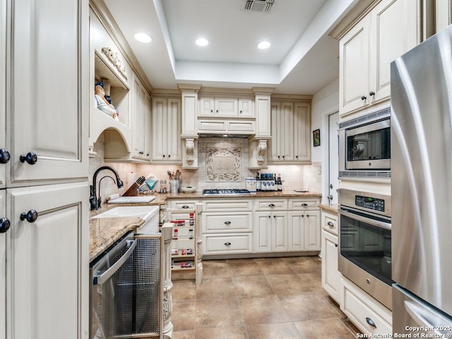 3318 Stone Cave, San Antonio, TX 78247 - kitchen featuring stainless steel appliances, tasteful backsplash, light stone counters, recessed lighting, and a sink