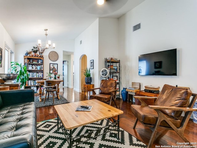 3318 Stone Cave, San Antonio, TX 78247 - living area featuring a chandelier, arched walkways, high vaulted ceiling, wood finished floors, and baseboards
