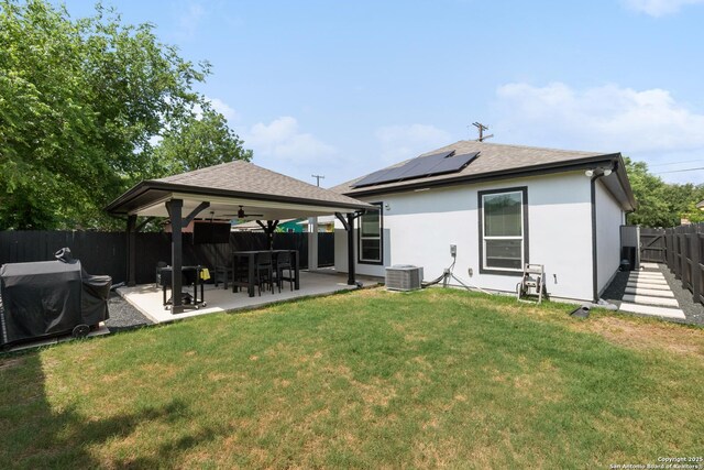 422 42nd, San Antonio, TX 78237 - rear view of house with roof mounted solar panels, a gazebo, a ceiling fan, a patio area, and central AC unit