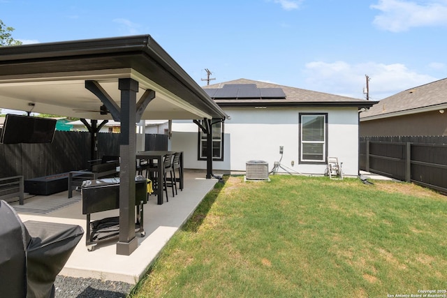 422 42nd, San Antonio, TX 78237 - rear view of property featuring stucco siding, a patio, solar panels, central air condition unit, and ceiling fan