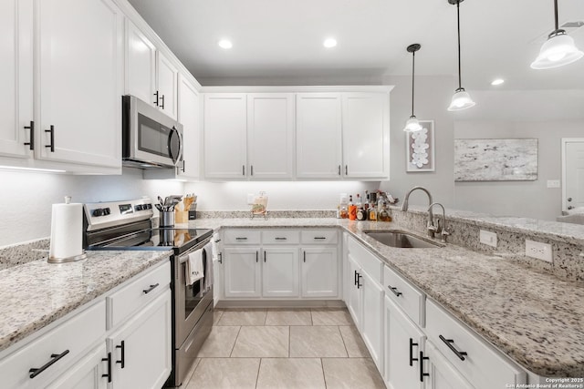422 42nd, San Antonio, TX 78237 - kitchen featuring stainless steel appliances, a sink, white cabinets, a peninsula, and recessed lighting