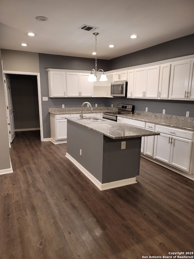 1038 W Ridgewood Ct, San Antonio, TX 78201 - kitchen with appliances with stainless steel finishes, a sink, white cabinets, recessed lighting, and dark wood-type flooring