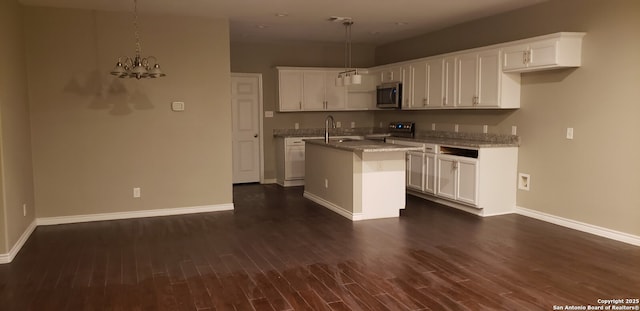 1038 W Ridgewood Ct, San Antonio, TX 78201 - kitchen with stainless steel appliances, baseboards, dark wood finished floors, and a chandelier