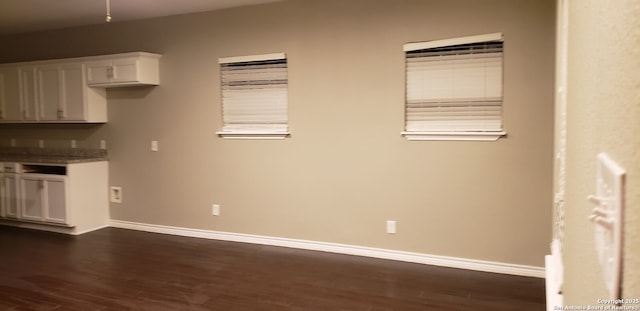 1038 W Ridgewood Ct, San Antonio, TX 78201 - kitchen featuring dark wood-style flooring, white cabinets, and baseboards
