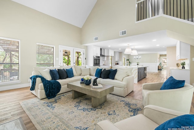 29302 Grand Coteau, Boerne, TX 78015 - living area featuring high vaulted ceiling, light wood-style flooring, baseboards, and a chandelier