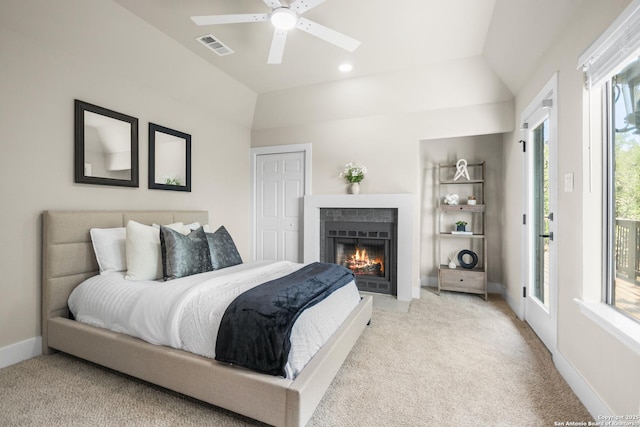 29302 Grand Coteau, Boerne, TX 78015 - bedroom with vaulted ceiling, access to outside, light carpet, a fireplace with flush hearth, and a ceiling fan