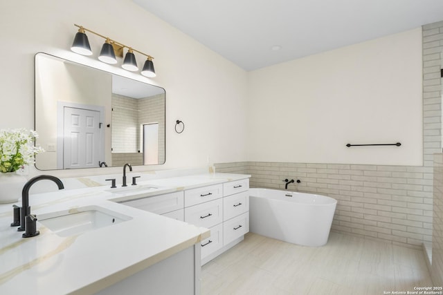 29302 Grand Coteau, Boerne, TX 78015 - full bathroom featuring tile walls, vanity, a soaking tub, and a wainscoted wall
