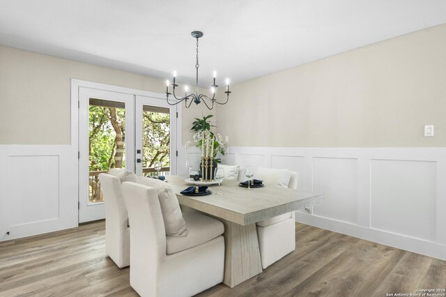 29302 Grand Coteau, Boerne, TX 78015 - dining room featuring wainscoting, a chandelier, a decorative wall, and light wood-style flooring