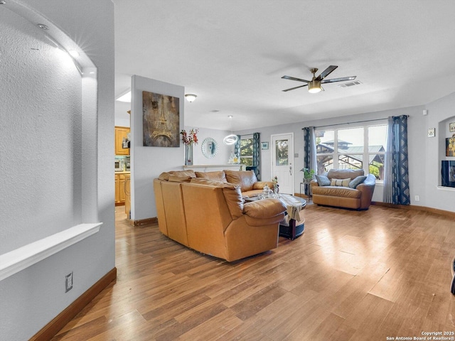7142 Coral Spgs, San Antonio, TX 78250 - living area featuring light wood finished floors, ceiling fan, and baseboards