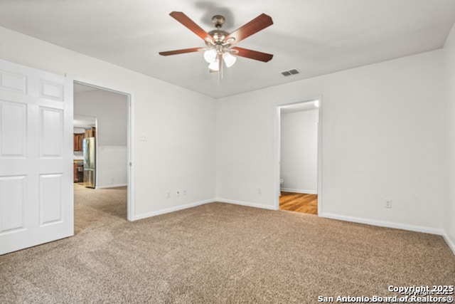 3823 Southern Sky, San Antonio, TX 78222 - unfurnished bedroom featuring carpet, freestanding refrigerator, baseboards, and a ceiling fan