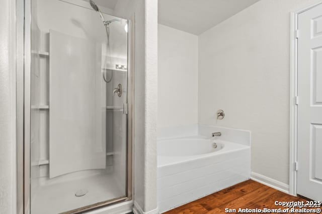 3823 Southern Sky, San Antonio, TX 78222 - full bath with a stall shower, wood finished floors, a garden tub, and baseboards
