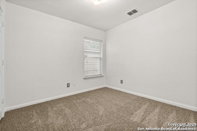 3823 Southern Sky, San Antonio, TX 78222 - carpeted empty room with baseboards, a textured ceiling, and lofted ceiling