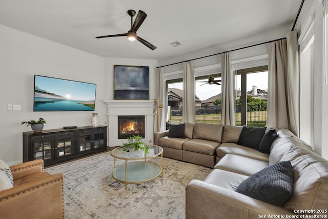 562 Orchard Way, New Braunfels, TX 78132 - living area featuring ceiling fan and a glass covered fireplace