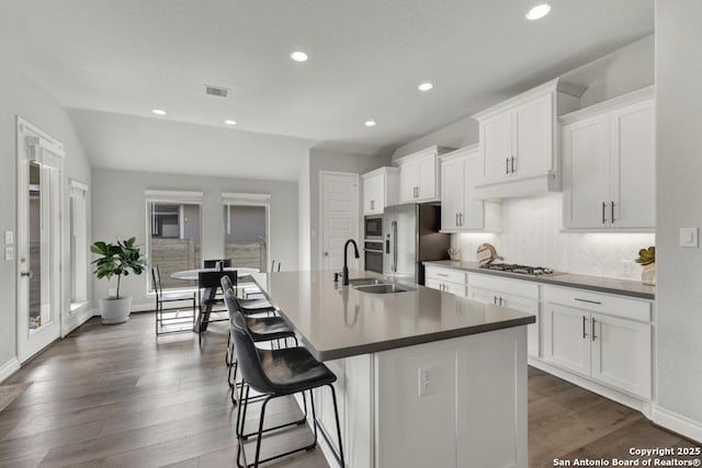 562 Orchard Way, New Braunfels, TX 78132 - kitchen with appliances with stainless steel finishes, a sink, an island with sink, dark wood-style floors, and recessed lighting