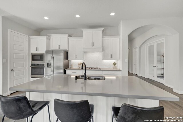 562 Orchard Way, New Braunfels, TX 78132 - kitchen featuring stainless steel appliances, a sink, white cabinetry, a kitchen island with sink, and recessed lighting