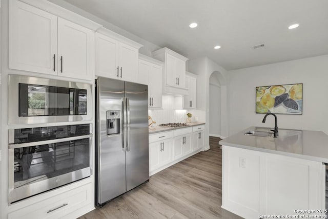 562 Orchard Way, New Braunfels, TX 78132 - kitchen with appliances with stainless steel finishes, a sink, tasteful backsplash, recessed lighting, and white cabinets