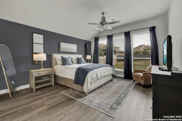 562 Orchard Way, New Braunfels, TX 78132 - bedroom with wood finished floors, vaulted ceiling, ceiling fan, and baseboards