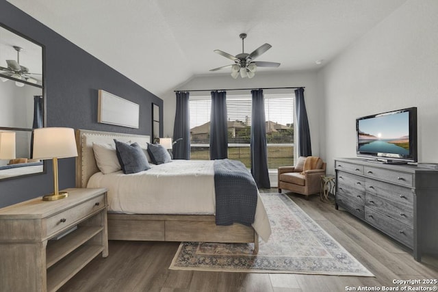 562 Orchard Way, New Braunfels, TX 78132 - bedroom featuring wood finished floors, vaulted ceiling, and a ceiling fan