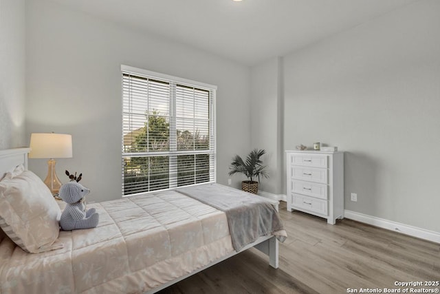 562 Orchard Way, New Braunfels, TX 78132 - bedroom with wood finished floors and baseboards
