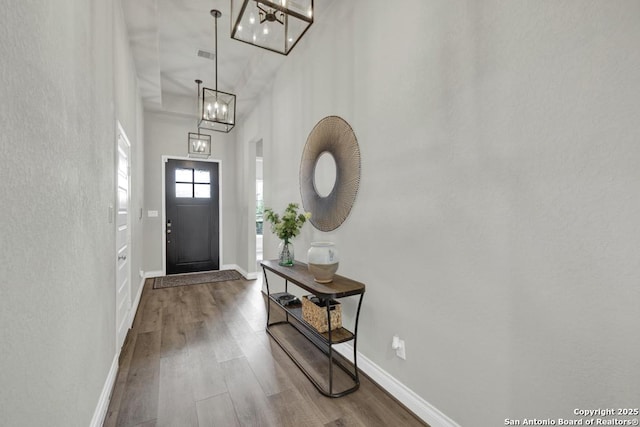 562 Orchard Way, New Braunfels, TX 78132 - entrance foyer featuring a chandelier, wood finished floors, baseboards, and a high ceiling