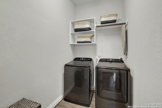 562 Orchard Way, New Braunfels, TX 78132 - washroom with independent washer and dryer, baseboards, light wood finished floors, and a textured wall
