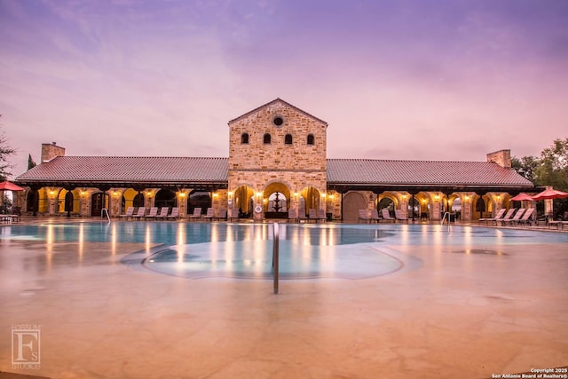 562 Orchard Way, New Braunfels, TX 78132 - property at dusk with a community pool