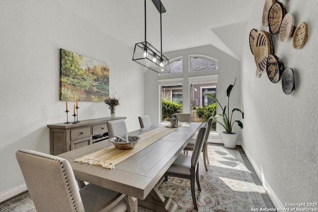 562 Orchard Way, New Braunfels, TX 78132 - dining area featuring baseboards, vaulted ceiling, and a textured wall
