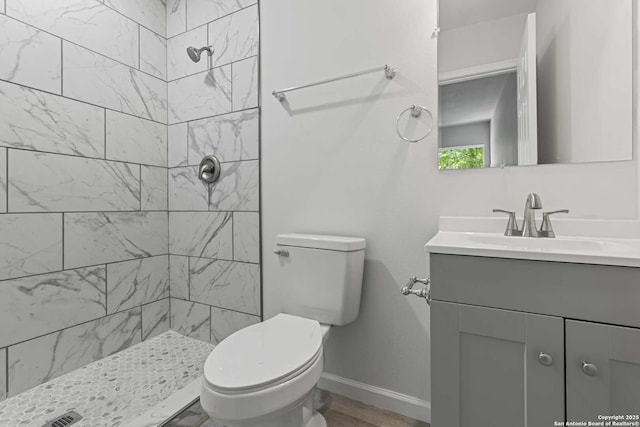 1711 Hermine, San Antonio, TX 78201 - bathroom featuring vanity, a tile shower, toilet, and baseboards