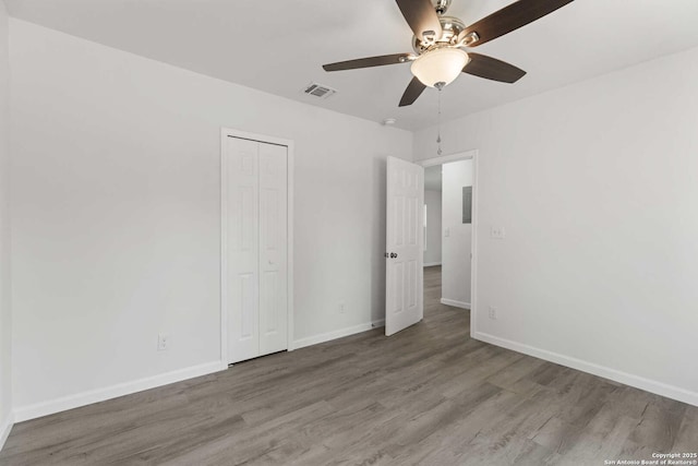 1711 Hermine, San Antonio, TX 78201 - unfurnished bedroom with wood finished floors, baseboards, a closet, and ceiling fan