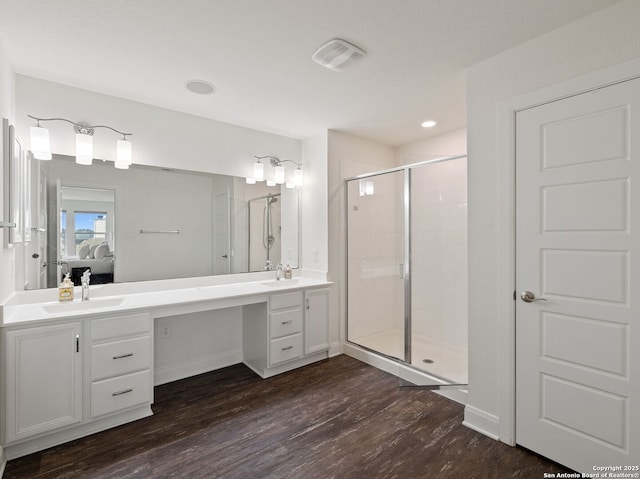 20310 Roche Oak, San Antonio, TX 78259 - ensuite bathroom featuring a stall shower, wood finished floors, double vanity, baseboards, and recessed lighting