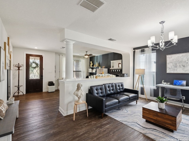 20310 Roche Oak, San Antonio, TX 78259 - living area with decorative columns, wood finished floors, a chandelier, baseboards, and a textured ceiling