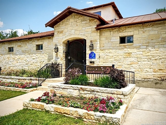 20310 Roche Oak, San Antonio, TX 78259 - view of exterior entry with stone siding, a standing seam roof, and metal roof