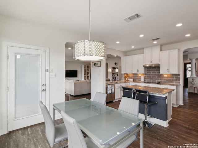 20310 Roche Oak, San Antonio, TX 78259 - dining area with arched walkways, dark wood finished floors, and recessed lighting