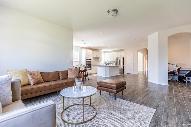 7421 Cimarron Lk, Boerne, TX 78015 - living area with arched walkways, dark wood-type flooring, and recessed lighting