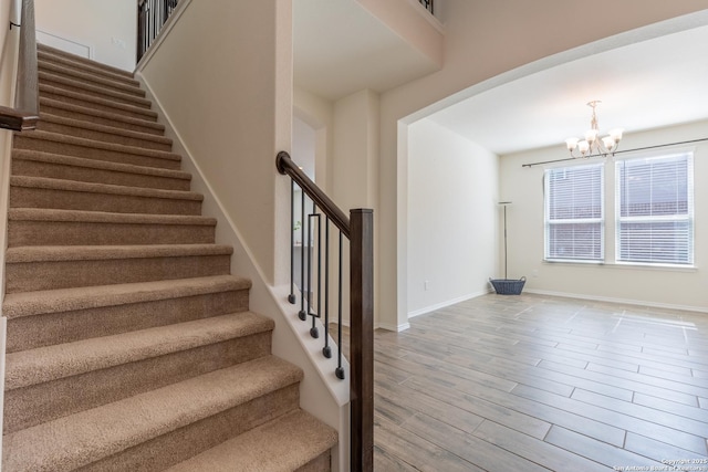 7421 Cimarron Lk, Boerne, TX 78015 - stairway with a chandelier, wood finished floors, and baseboards