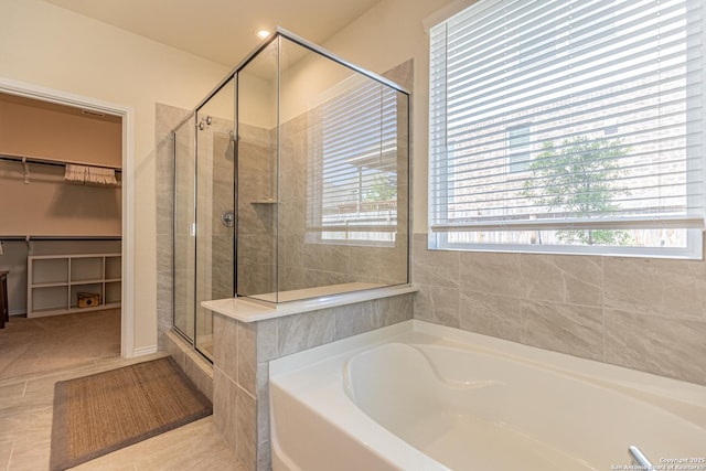 7421 Cimarron Lk, Boerne, TX 78015 - full bathroom featuring a bath, a stall shower, a spacious closet, and tile patterned floors